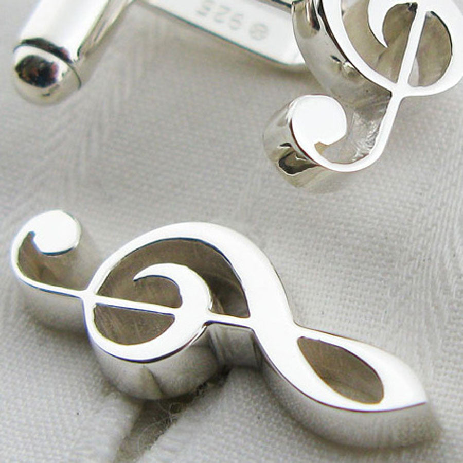 close-up of treble clef cufflinks