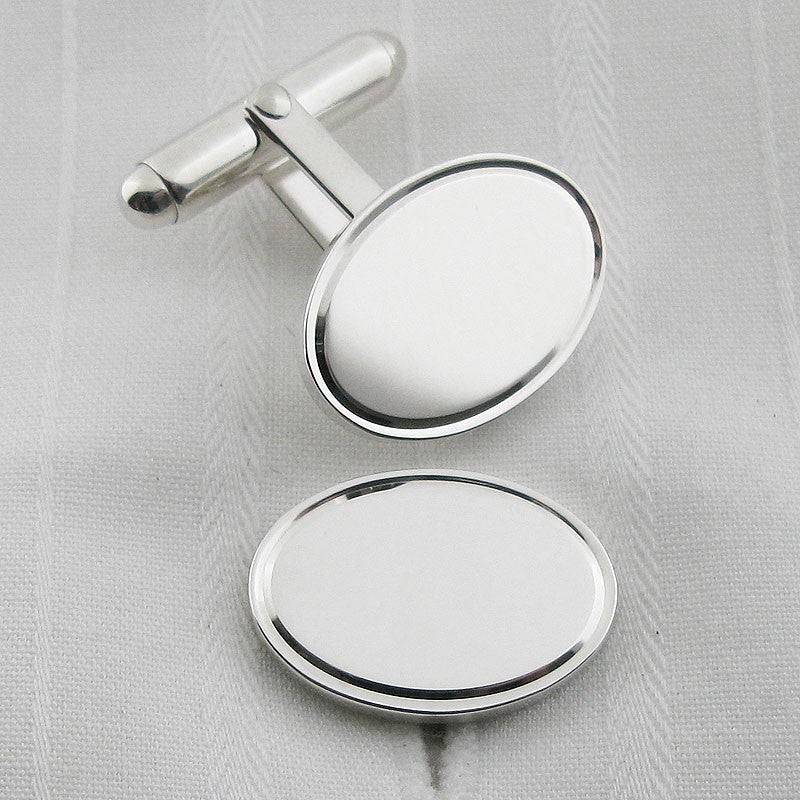 Oval silver cufflinks with engraved border