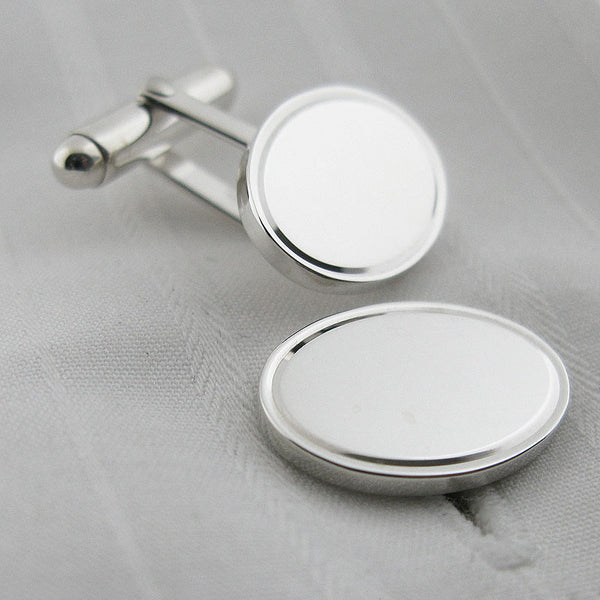 Oval silver cufflinks with engraved border