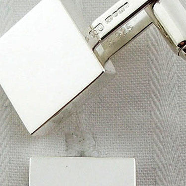 close-up of heavy square silver cufflinks